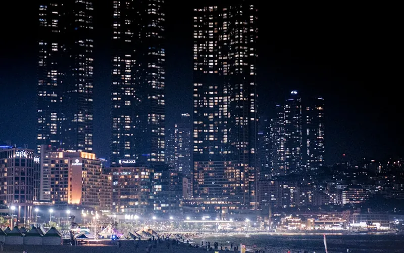 A city at night with lit building facades