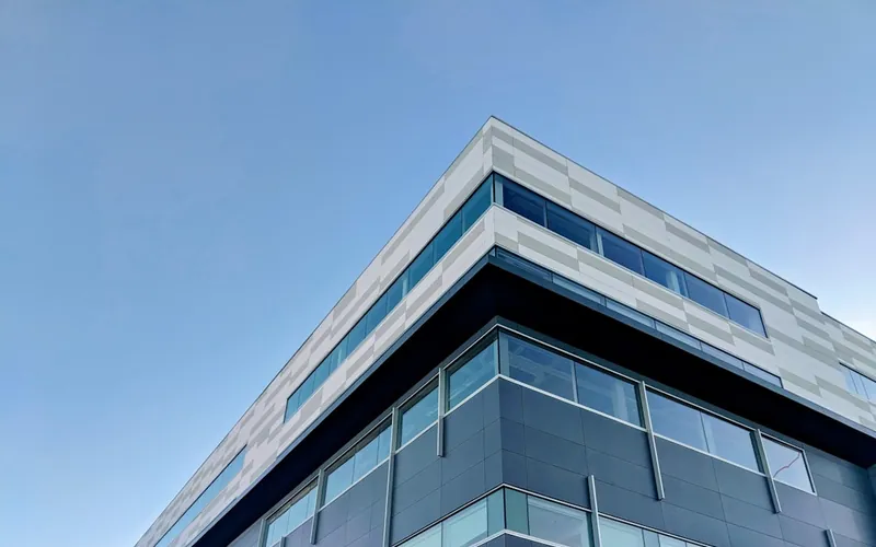 The glass facade of a modern office building