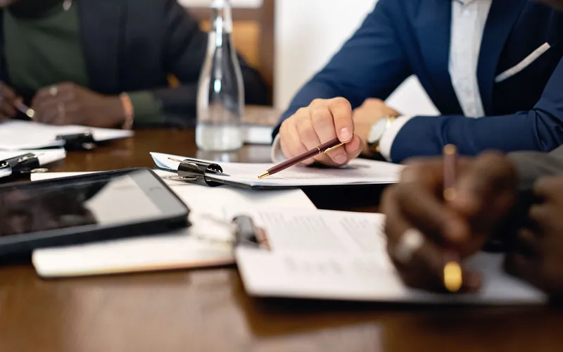 People reviewing documents across a meeting table
